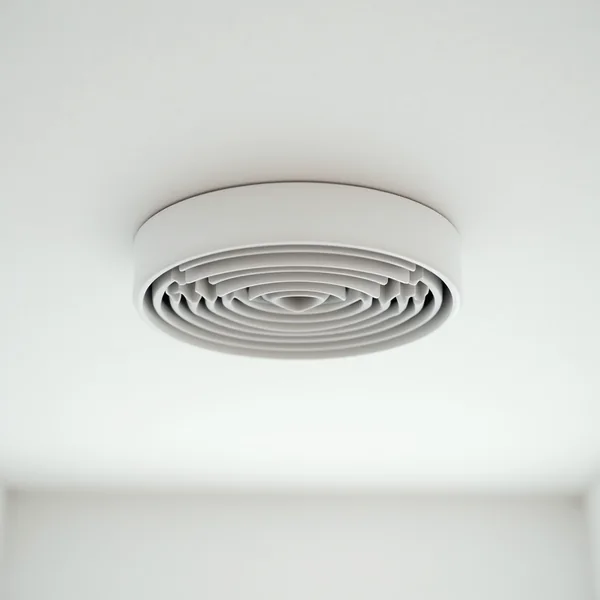 A round white ceiling exhaust vent with concentric louvres mounted on a smooth white bathroom ceiling